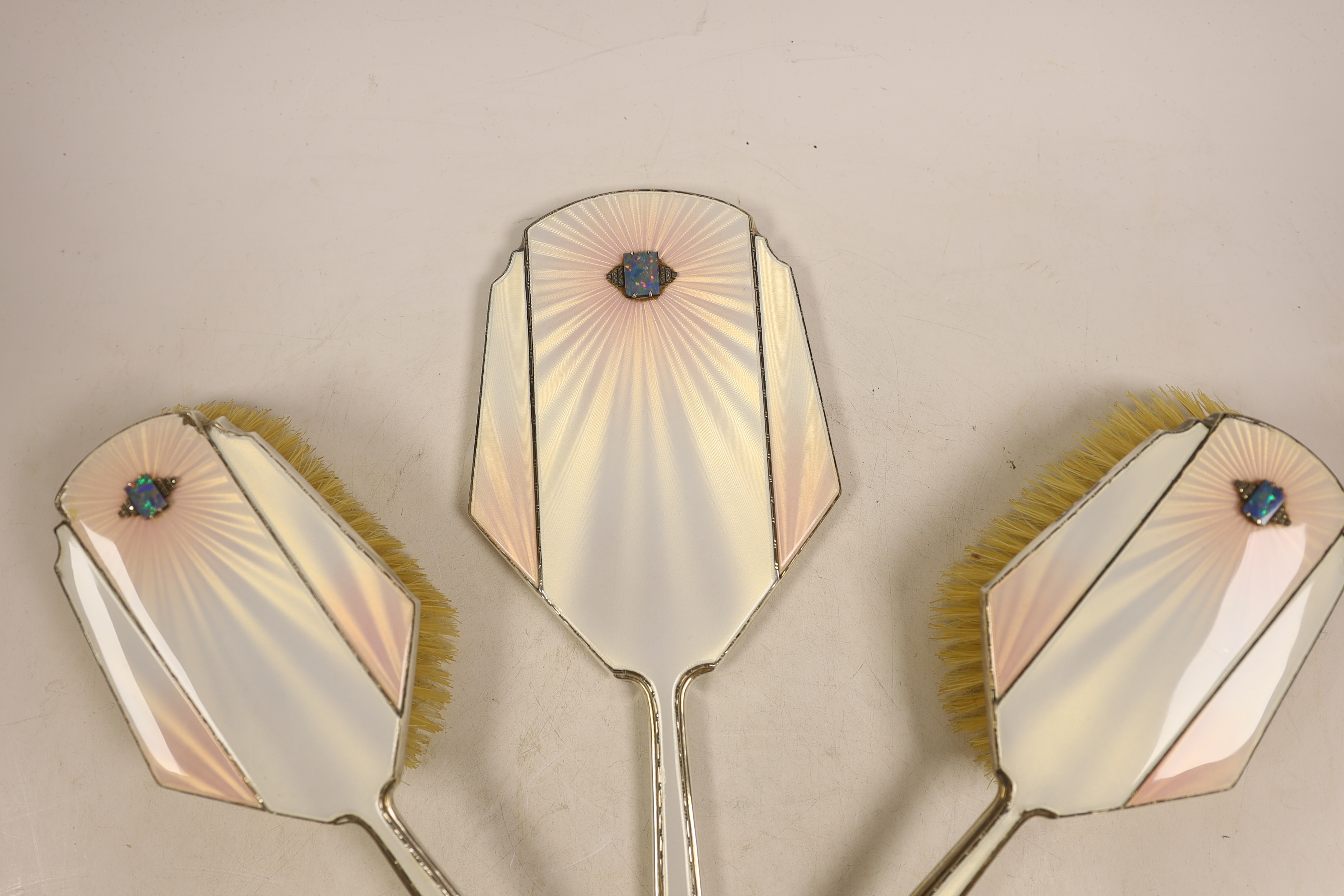 An Art Deco Mappin & Webb silver, enamel, marcasite and black opal mounted six piece mirror, comb (lacking teeth) and brush set, Birmingham, 1935